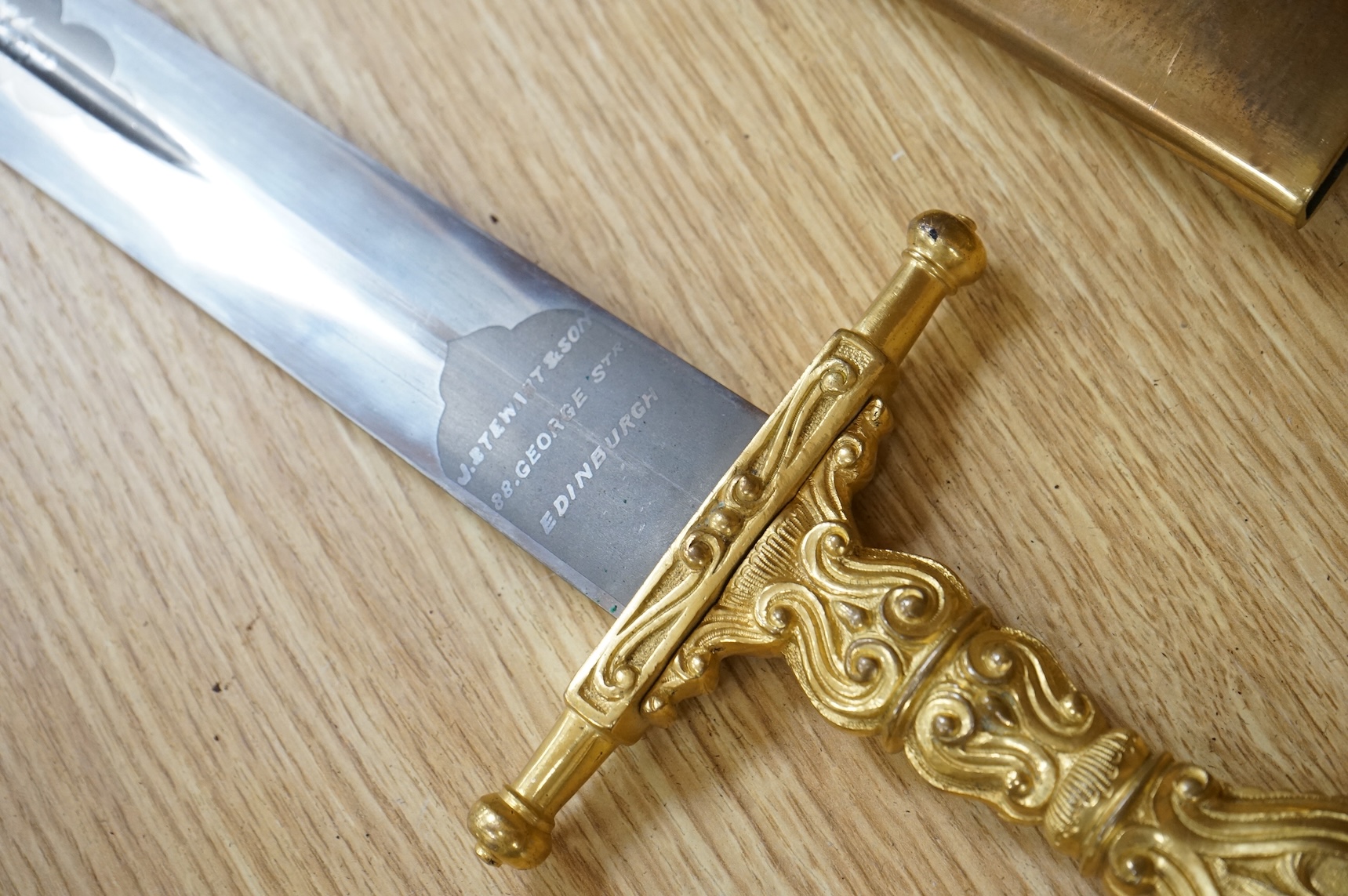 A Scottish sidearm for the King’s Own Bodyguard for Scotland, straight blade by J. Stewart and Son, etched and polished regulation blade, ormolu hilt, in its leather scabbard with ormolu mounts (gilding worn to mounts)